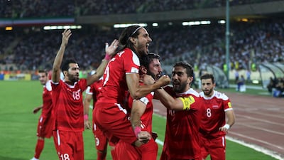 Syria's players drew 2-2 against Iran, a result that ensured they qualified for the play-offs. Vahid Salemi / AP Photo