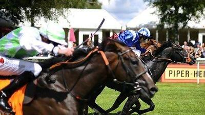 Paul Hanagan, in blue, rides Alhebayeb to victory.