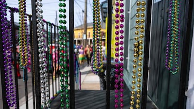 Mardi Gras beads, a well-known party item, hang from the banister of a front porch in New Orleans. AFP