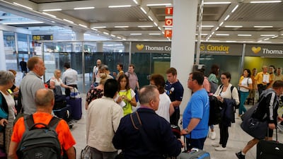 Passengers are seen at Thomas Cook check-in points at Mallorca Airport as an announcement is expected on the tour operator's attempts to secure 200 million pounds in extra funding to reach agreement over its recapitalisation and secure its future, Palma de Mallorca, Spain. REUTERS