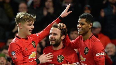 Juan Mata celebrates with teammates Brandon Williams (L) and Marcus Rashford (R) after scoring the opening goal. EPA