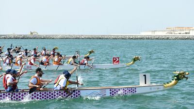 The Hong Kong Economic Trade Office team, centre, race against Waterfront Market, DP World 2 and Cortex at the Hong Kong Dragon Boat Festival.