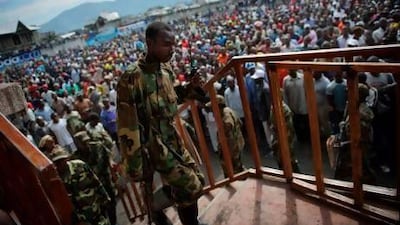 An M23 rebel soldier climbs the Volcanoes Stadium in Goma, where the rebel group’s spokesman, Vianney Kazarama, addressed the population in an attempt to calm and reassure civilians.