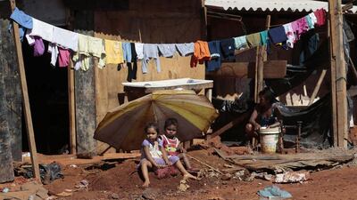 Two children sit in front of their home in the Santa Luzia slum, before the residents protest against the money spent on preparations of the upcoming World Cup, in Brasilia. The 2014 World Cup will be held in 12 cities in Brazil from June 12 till July 13. Joedson Alves / Reuters