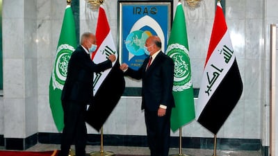 Iraqi Foreign Minister Fuad Hussein, right, greets Ahmed Aboul Gheit, Secretary General of the Arab League, in Baghdad. AP