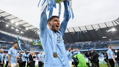 Ruben Dias of Manchester City celebrates with the Premier League Trophy. Getty