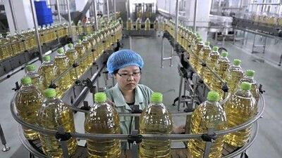 An employee works at the production line of an edible oil company in Sanhe, China. Reuters