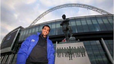 Ahmed Alkaf, a football referee from Oman, stands beside the Bobby Moore statue at Wembley Stadium after taking part in a referees development programme in London.