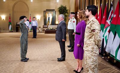 King Abdullah II welcomes Princess Salma for a ceremony to present her with her wings, alongside Queen Rania and Crown Prince Al Hussein bin Abdullah. AFP