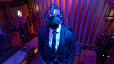 An 'agent' wearing the VR headset and gear before the 'MIB: First Assignment' adventure at Dreamscape in Mall of the Emirates. Antonie Robertson / The National