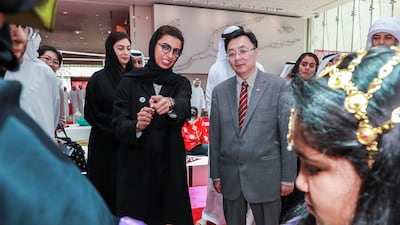 Noura Al Kaabi, Minister of Culture and Knowledge Development, and Ni Jian, Ambassador of China (R) check out a henna station at the launch UAE- China Week in Manarat Al Saadiyat. Victor Besa / The National