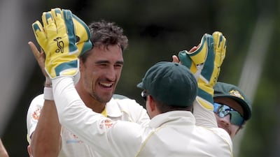 Australia's Mitchell Starc, left, celebrates with captain Tim Paine after they dismissed Sri Lanka's Kusal Perera on Day 4 of the second Test at Manuka Oval in Canberra. EPA