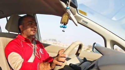 Safdar Abbas, from Pakistan, drives the company car on the way to deliver mail. Lee Hoagland / The National