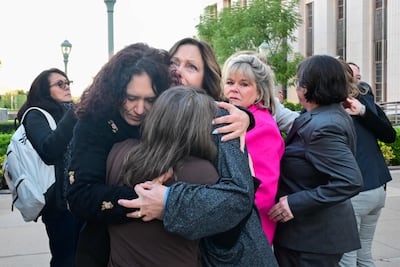 Parents and family members, including some plaintiffs, embrace before entering the Los Angeles Superior Court for the social media trial. AFP