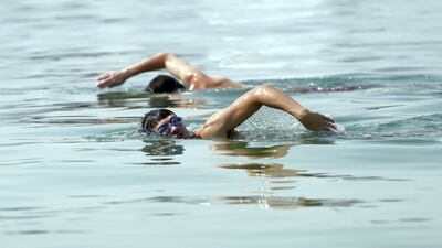 Sherif and Omar Saadawi in a charity swim around the Palm Jumeirah to support diabetes research. Chris Whiteoak / The National