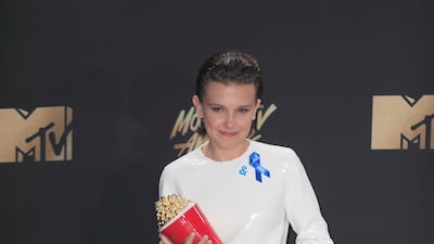 Millie Bobby Brown, wearing white Calvin Klein with cowboy boots, attends the MTV Movie & TV Awards in Los Angeles on May 7, 2017. EPA