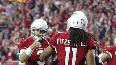 Arizona Cardinals quarterback Carson Palmer points to receiver Larry Fitzgerald after a touchdown on Sunday in their NFL win over the Green Bay Packers. Ross D Franklin / AP / December 27, 2015