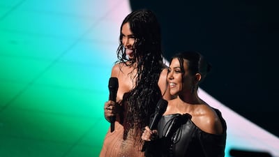 Actress Megan Fox, left, and Kourtney Kardashian speak on stage. AFP