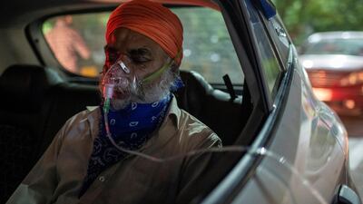 A man suffering from shortness of breath receives free oxygen inside his car at a gurudwara, Sikh temple, amid the spread of coronavirus, in northern Indian city of Ghaziabad. Reuters