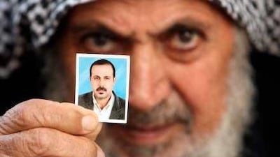 Mahmoud al Mabhouh holds a picture of his son, a senior Hamas commander killed in Dubai, at his family home in Gaza yesterday.