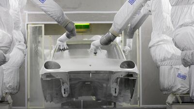 Robot arms coat a Porsche Macan at the company’s new plant in Leipzig, Germany. Tobias Schwarz / Reuters