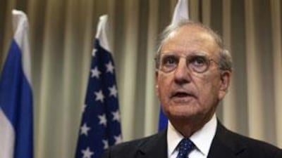 George Mitchell, attends a photo opportunity with Israel's Defence Minister Ehud Barak (not pictured) in Tel Aviv.