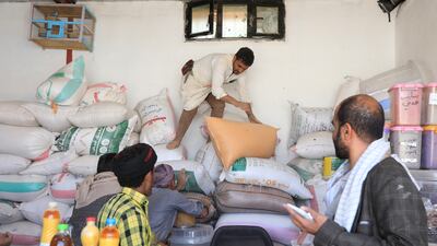 Yemenis try to buy grain at a market in Sanaa on Monday. The escalation of Houthi attacks on shipping lanes in the Red Sea and the Gulf of Aden could put further pressure on food prices. EPA