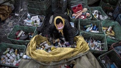 A Chinese labourer sorts plastic before being recycled in the Dong Xiao Kou village. Kevin Frayer / Getty Images