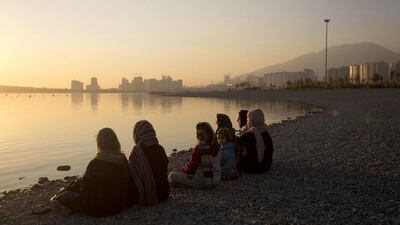 A group of women sit on the shore of an artificial lake in Chitgar Park, north-west of Tehran (Photographer: Simon Dawson/Bloomberg)