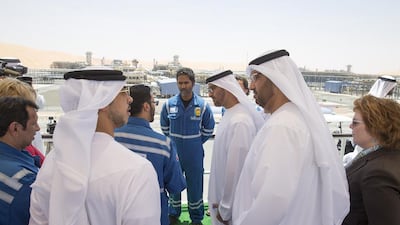 Sheikh Mohammed bin Zayed, centre, Crown Prince of Abu Dhabi and Deputy Supreme Commander of the UAE Armed Forces, speaks with an Al Hosn Gas employee. Also in the picture are US ambassador to the UAE Barbara Leaf, right, Sultan Al Jaber, chief exective of Adnoc, second right, and Sheikh Mansour bin Zayed, Deputy Prime Minister and Minister of Presidential Affairs, second left. Mohamed Al Hammadi / Crown Prince Court - Abu Dhabi