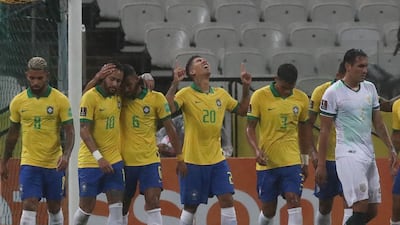 Brazil's Roberto Firmino (C) celebrates with teammates after scoring. AFP