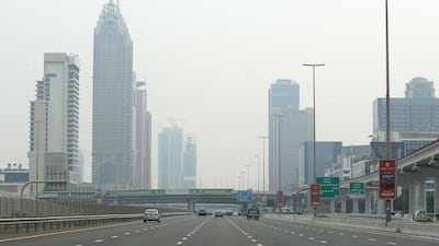 Traffic passes through Dubai's Sheikh Zayed Road as hot and hazy weather hits the city. Pawan Singh / The National