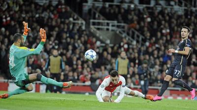 Arsenal’s Mesut Ozil scores their first goal on Tuesday night in their Champions League contest at the Emirates Stadium. Gerry Penny / EPA