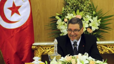 Tunisia's Prime Minister Habib Essid shares a smile with ministers prior to an extraordinary cabinet meeting in Carthage, outside Tunis, to end the cycle of unrest that has pummelled towns across the country five years after the nation overthrew its longtime ruler. (AP Photo/Riadh Dridi)
