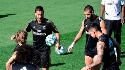 Eden Hazard, left, and Karim Benzema take part in a training session. AFP