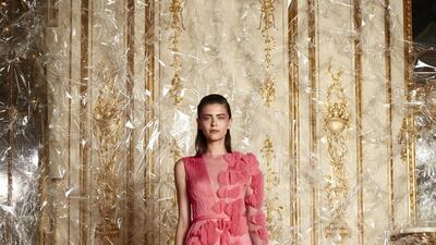 Tone on tone flowers on a coral plisse gown