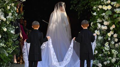 The twins were tasked with getting Meghan's train - which was embroidered with flowers from across the Commonwealth - ready to go down the aisle. Getty