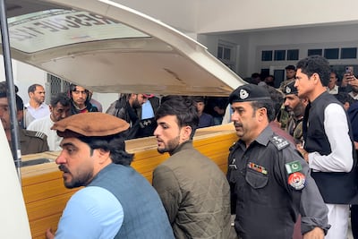 People carry a teacher's body into an ambulance from a hospital after a sectarian violence inside a school in Parachinar, Pakistan, on May 4. Five teachers and two labourers were gunned down. AFP