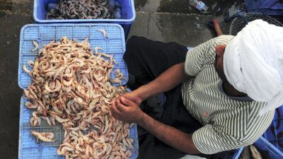 A Saudi vendor sells shrimp at a seafood market in Dammam. Reuters