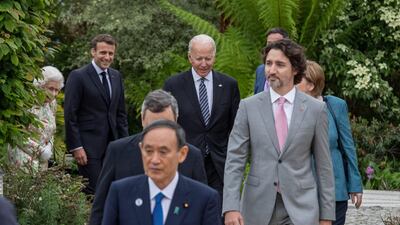 Canadian Prime Minister Justin Trudeau went against the sea of dark suits in a pale grey two-piece, paired with a pink tie. Reuters