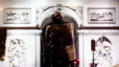 Riot police stand on the Champs-Elysees. EPA
