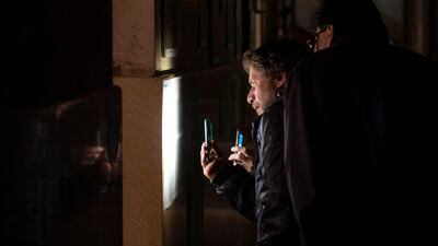 People check for their voting desk in Governor elections among a power outage in Rosario, Santa Fe province, Argentina. EPA