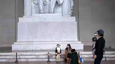 A boy dressed as a revolutionary visits the Lincoln Memorial with others during Halloween in Washington. AFP