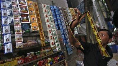 A vendor arranges sachets of gutka at his roadside stall in Kolkata. Ten Indian states have banned the popular chewing tobacco made of crushed betel nut, nicotine and laced with thousands of chemicals.