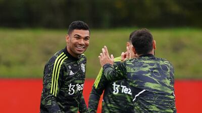 Manchester United's Casemiro jokes with Bruno Fernandes during training. PA