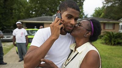 Octavia Lacey, the aunt of fallen Baton Rouge policeman Montrell Jackson gives a kiss to Kedrick Pitts, Montrell Jackson’s half-brother, in front of Montrell’s mother’s house in Baton Rouge. Jackson was one of the law enforcement officers who were shot and killed on Sunday morning. Max Becherer / AP