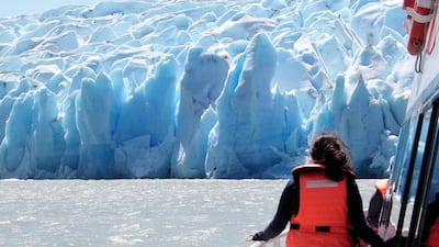 Tourists observe the Grey Glacier at the tail of the Southern Patagonian Ice Field in Chile. The park reached 20 degrees celsius on 25 December, a record in the middle of southern winter. EPA / Javier Martin