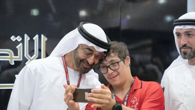Sheikh Mohamed bin Zayed Al Nahyan, left, stands for a selfie with a participant in the Special Olympics World Games Abu Dhabi 2019. Mohamed Al Hammadi / Ministry of Presidential Affairs