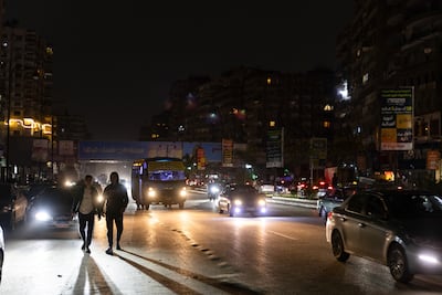 Traffic in Cairo, where streetlights have been switched off to conserve energy. Bloomberg