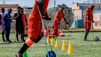 A Palestinian amputee using crutches participates in a football training in the central Gaza Strip last week. Said Khatib / AFP